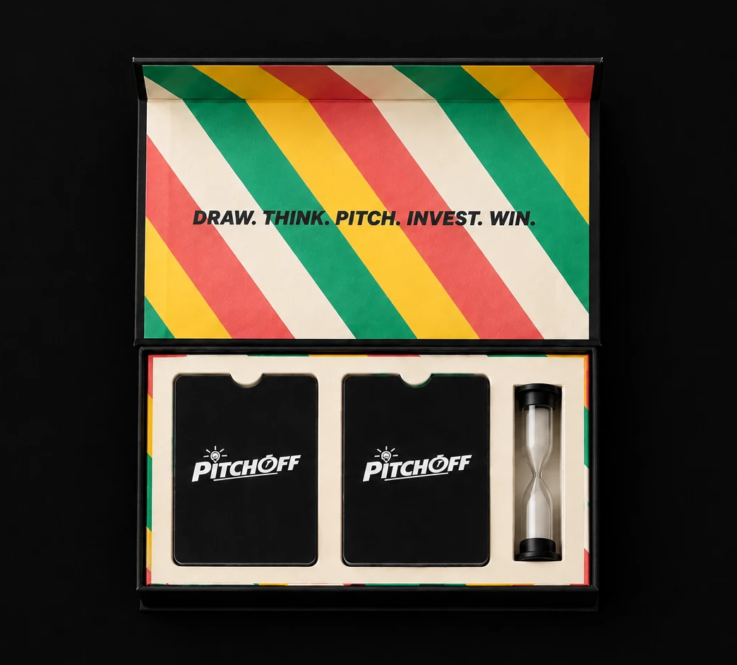 Top-down view of the open PITCH OFF box: lid lined with green, yellow, coral and cream stripes reading DRAW. THINK. PITCH. INVEST. WIN., and a cream insert holding two decks of black PITCH OFF cards and a sand hourglass